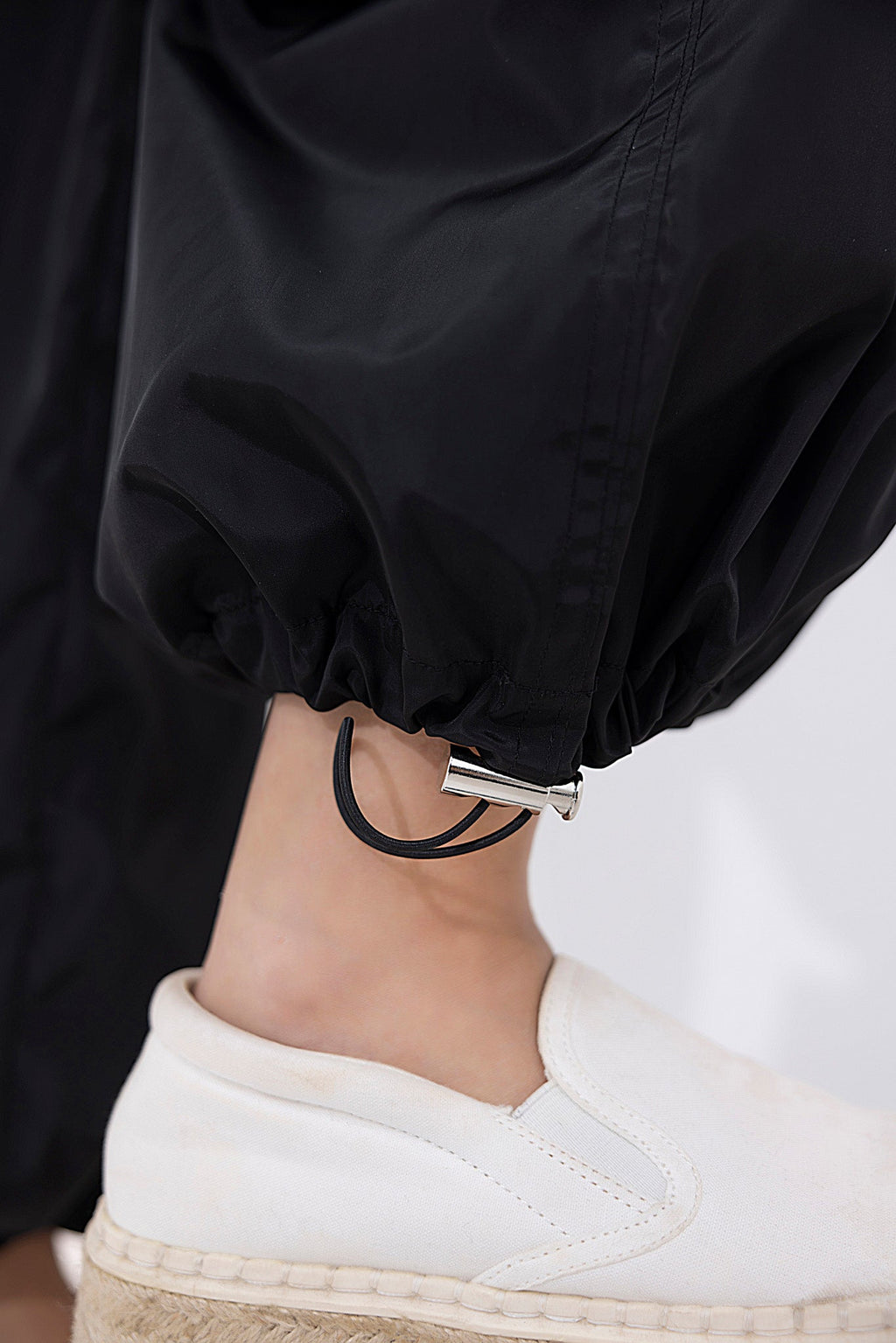 Women's black parachute cargo pants.