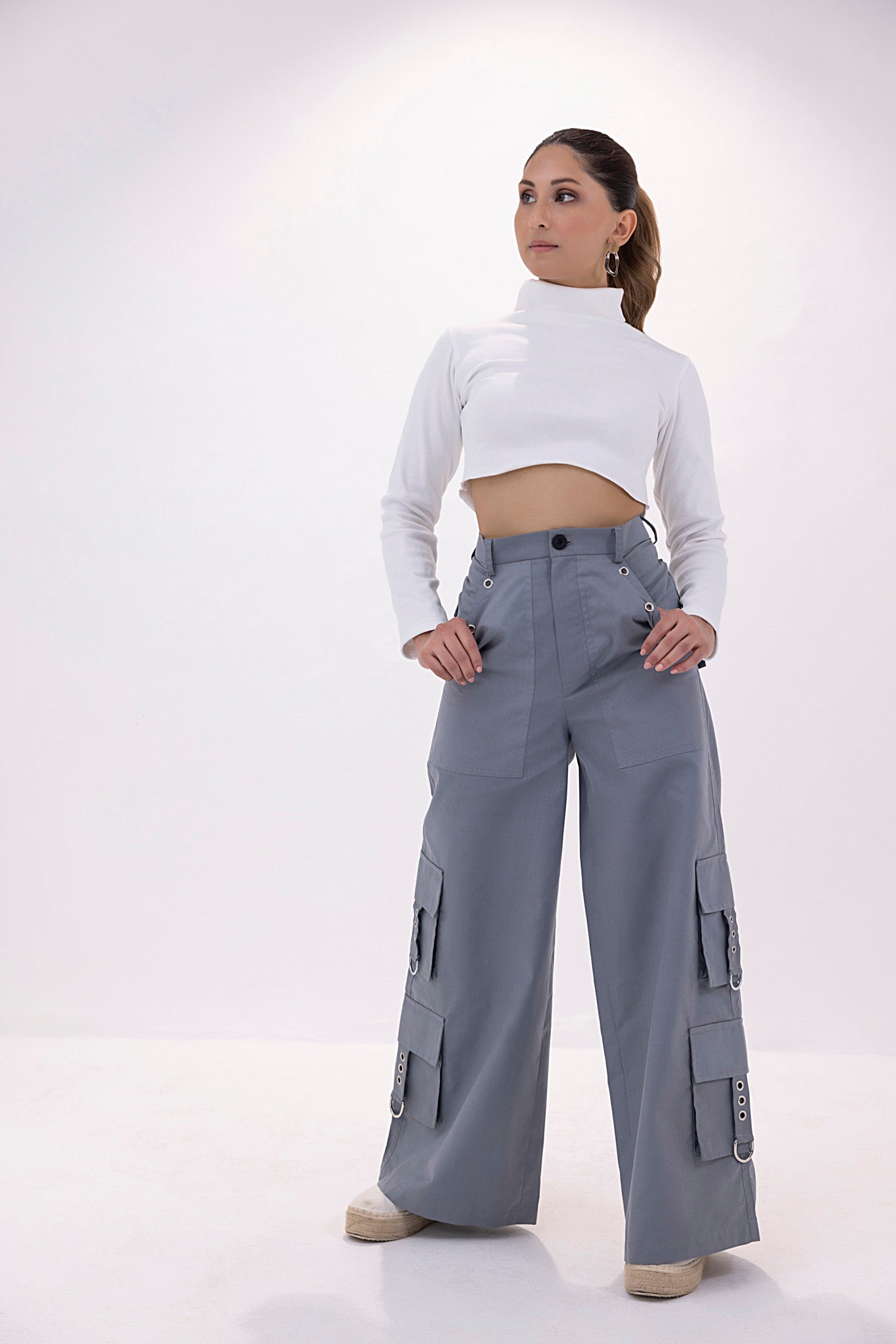 Grey women’s fancy cargo pants with multiple pockets and a tailored fit.