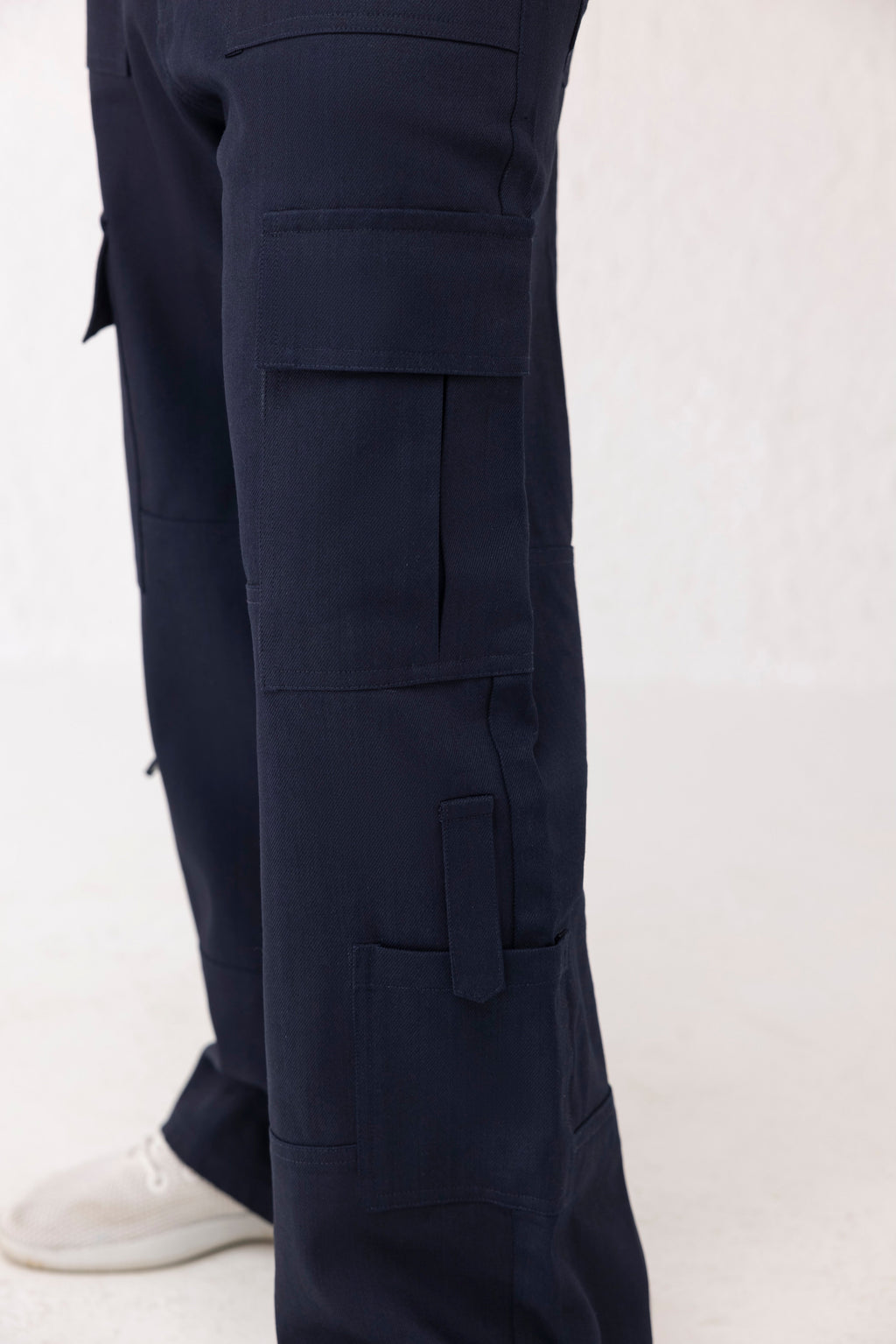 Close up of navy blue twill fabric and pocket structure on Aether wide leg men’s cargo pants