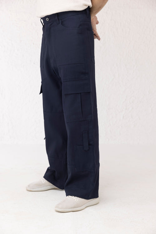 Side profile of dark blue wide leg cargo pants with clean finish and spacious pockets