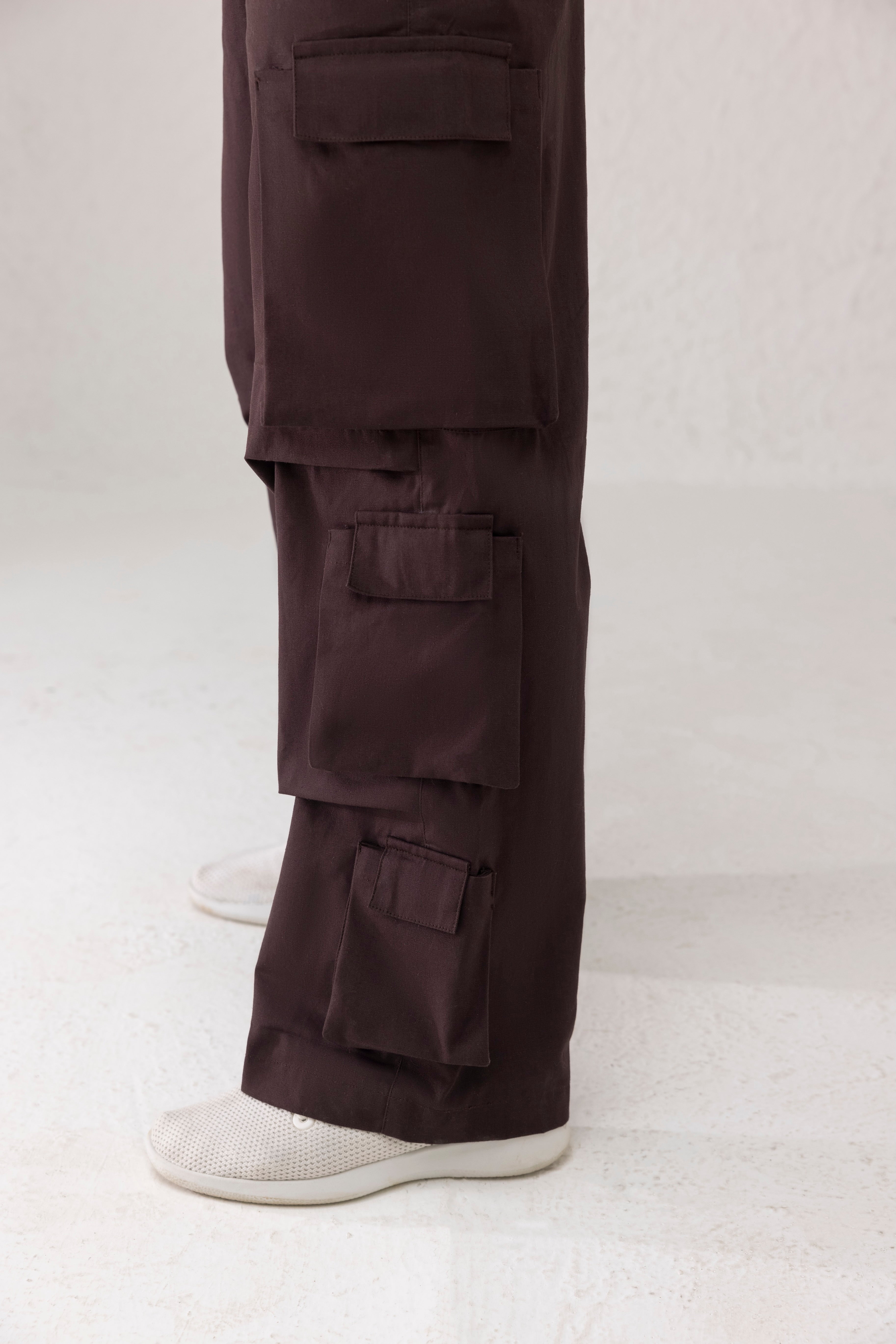 Close-up of side funnel pockets and twill texture on coffee brown cargo pants
