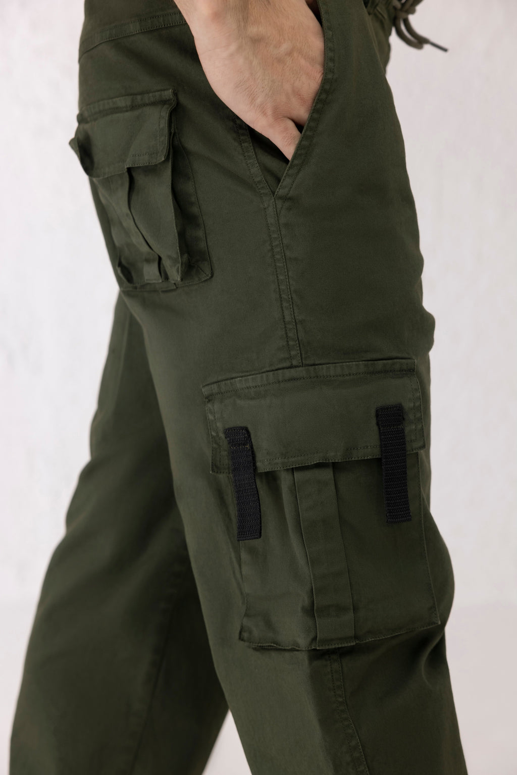 Close up of drawstring hem and twill texture on Everstride men’s dark green cargo pants