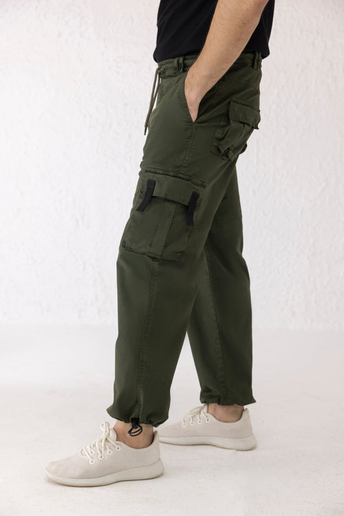 Side view of dark green twill cargo pants for men with utility pockets and adjustable drawstring hem