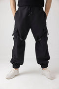 Front view of Nyxbound Strap Utility Cargo Pants in black with elastic waist and clean athletic design