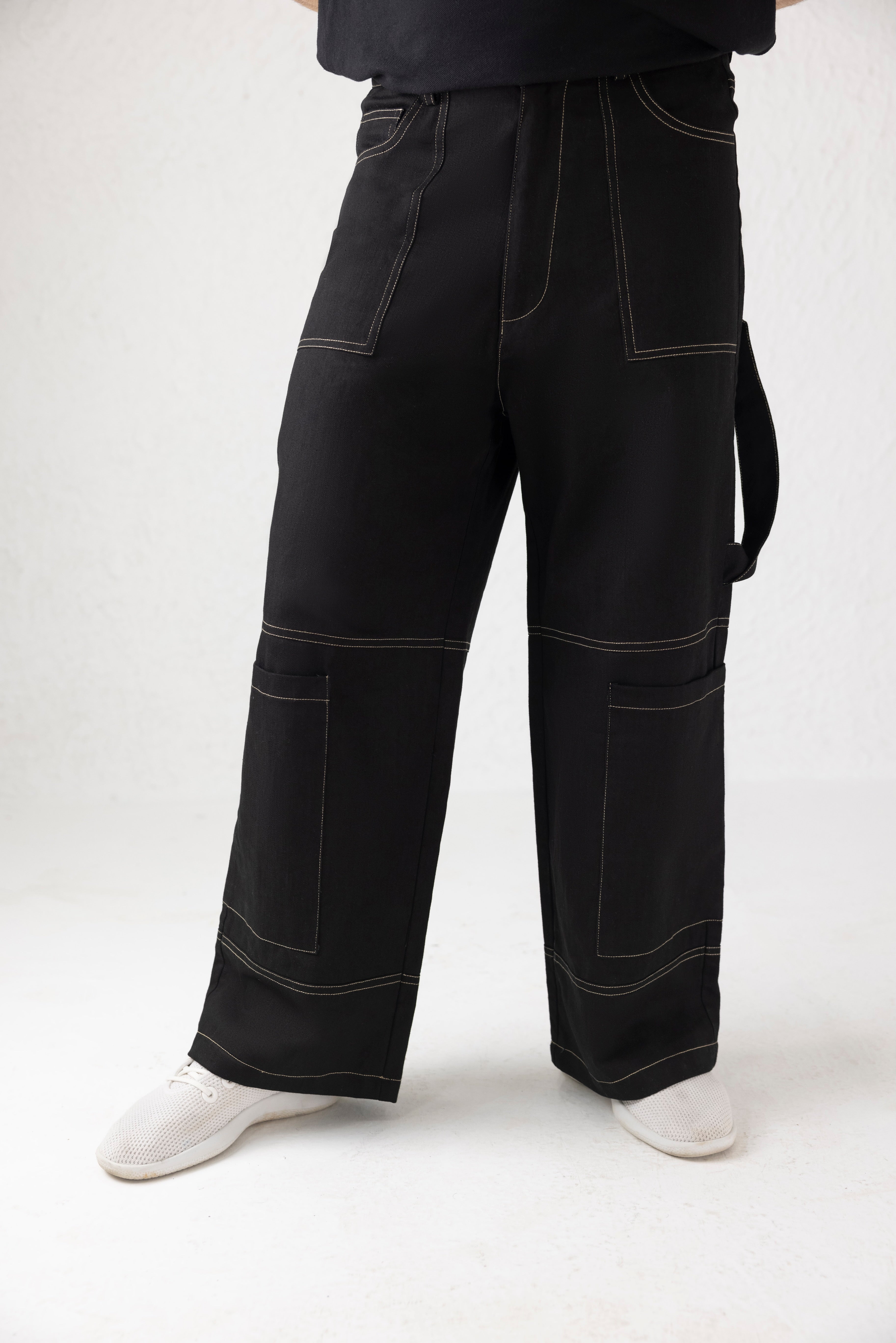 Front view of Onyxdrop Belted Denim Cargo Pants in black with light brown stitching and wide leg fit